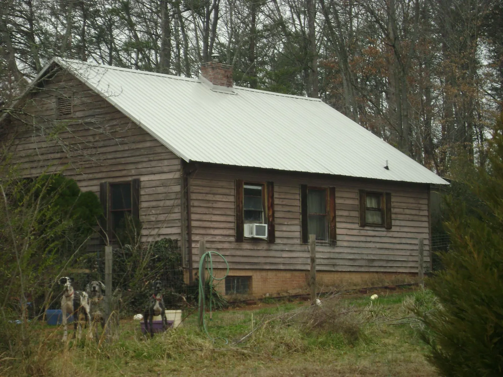 White metal roof on an old wood sided farmhouse, from a Metal Roof Installation job in Staffordsville